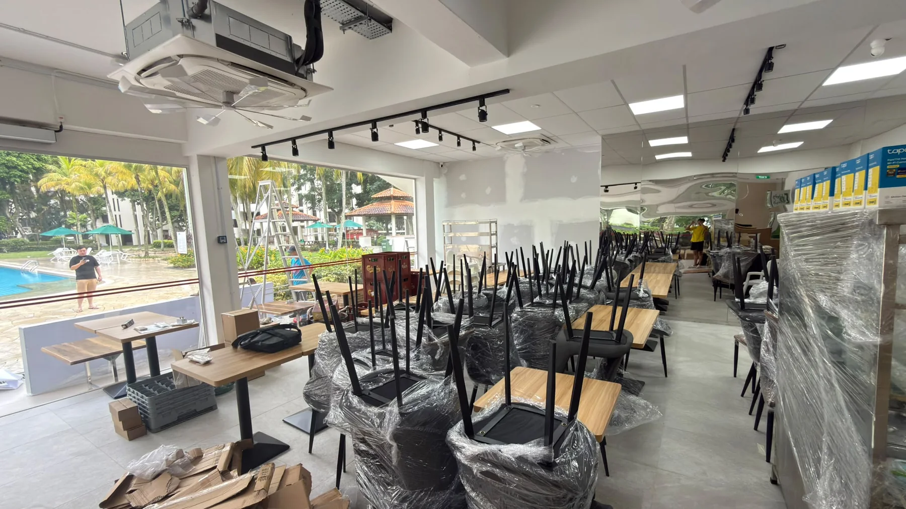 A restaurant dining room delivered by Casa, tables in place and chairs still wrapped ahead of opening