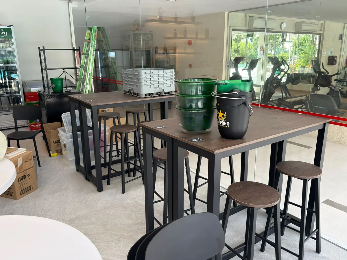 Bar-height tables and stools with black industrial frames supplied by Casa Furnishing